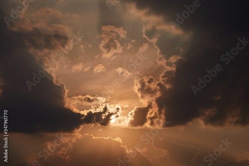 Sunset with dark clouds in the glowing sky