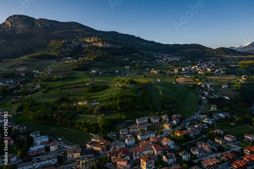 Italy, Trento, 01 May 2019: Panorama of the city at sunset, facade of buildings, Picturesque view of mountains through evening smoke photo