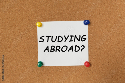 Text STUDYING ABROAD written on a sticker