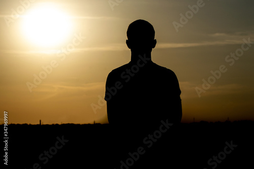 silhouette portrait of a young man at sunset.