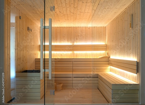 Front view of empty Finnish sauna room. Modern interior of wooden spa cabin with dry steam