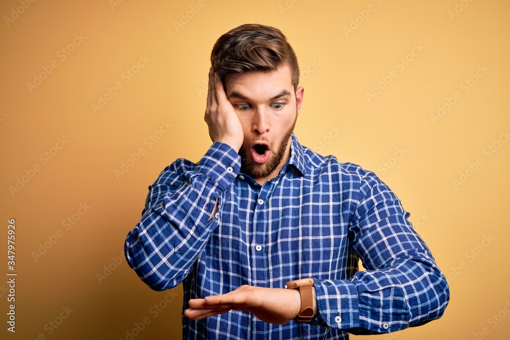 Young blond businessman with beard and blue eyes wearing shirt over ...