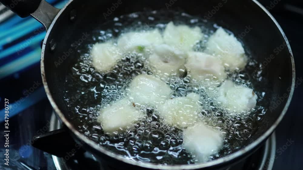 Onion vada with hot oil boiling in cooking pan closeup view, Indian dish making in a traditional home method , some area this is called ulli vada. Onion vada with hot oil boiling in cooking pan closeup view, Indian dish making in a traditional home method , some area this is called ulli vada.