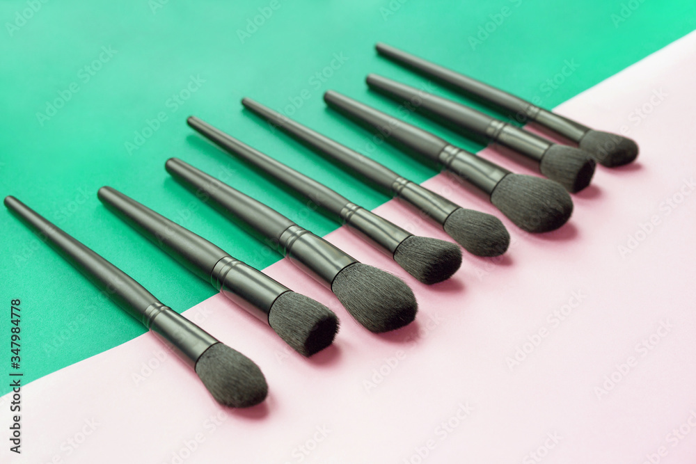 Makeup brushes on a colorful background. View from above Makeup brushes on a colorful background. View from above