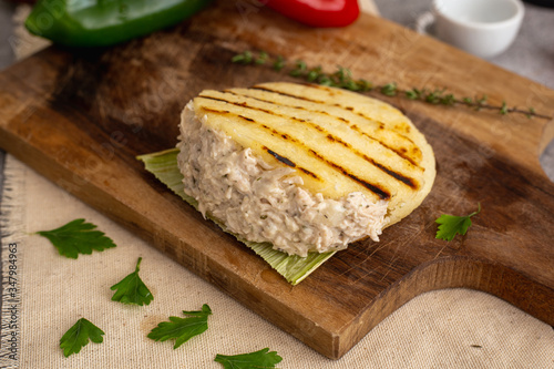 Chicken arepa with on wooden board (Colombian and Venezuelan typical food) photo