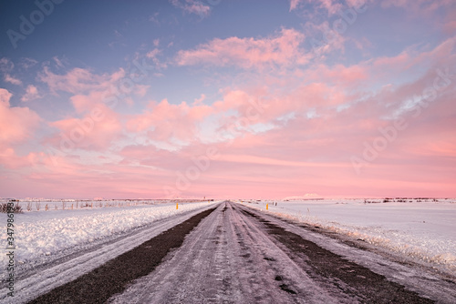 Pink sunset in an iced road in Iceland