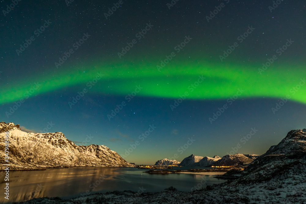 A wonderful night with Kp 5 northern lights flying over the mountains, long shutter speed. Nature of Norway