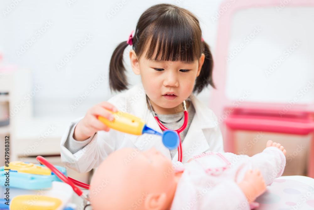toddler girl pretend play doctor role at home against white background toddler girl pretend play doctor role at home against white background