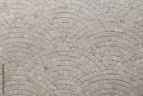 Beige mosaic tile texture on the bathroom wall