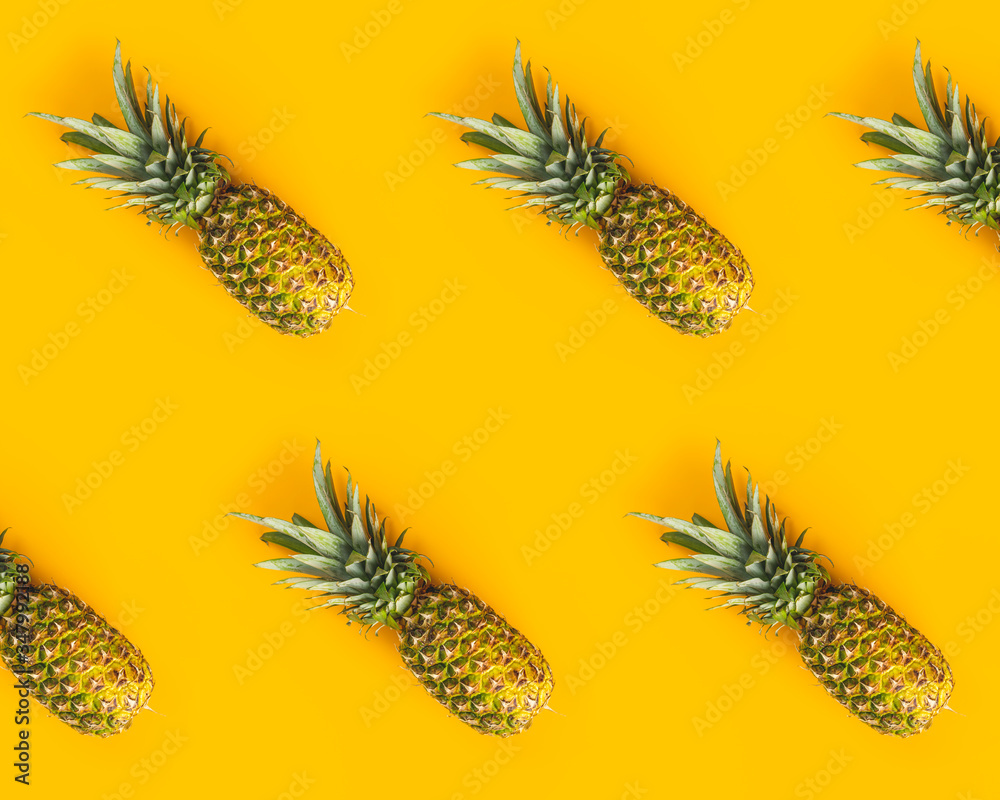 Fresh ripe pineapples on yellow background. Summer concept. Creative flat lay with copy space. Top view. Fresh ripe pineapples on yellow background. Summer concept. Creative flat lay with copy space. Top view.