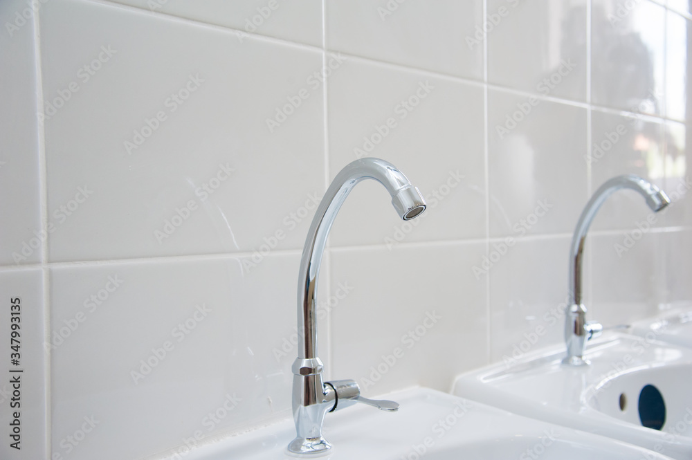 Close-up of row modern ceramic wash hand basins Close-up of row modern ceramic wash hand basins