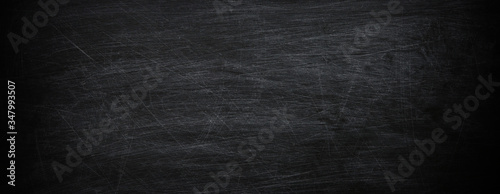 Dark, grunge and scratched black texture may used as background