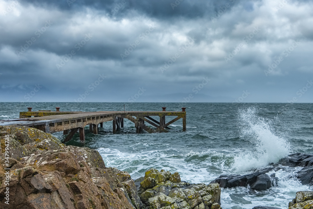 A stormy Portencross harbour and Jetty on the West Coast of Scotland.