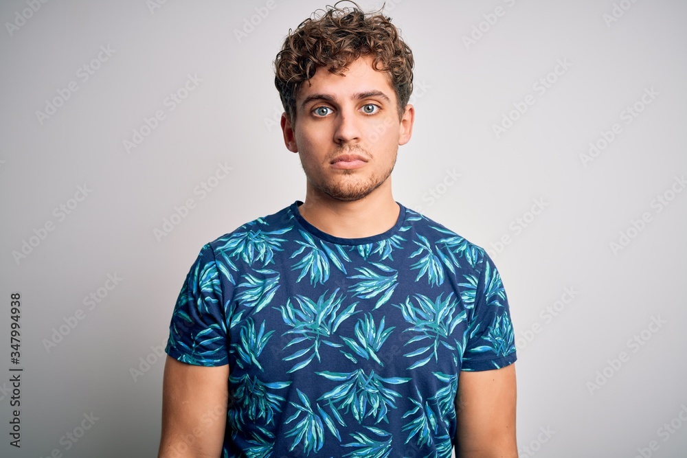 Young blond handsome man on vacation with curly hair wearing casual summer t-shirt depressed and worry for distress, crying angry and afraid. Sad expression. Young blond handsome man on vacation with curly hair wearing casual summer t-shirt depressed and worry for distress, crying angry and afraid. Sad expression.