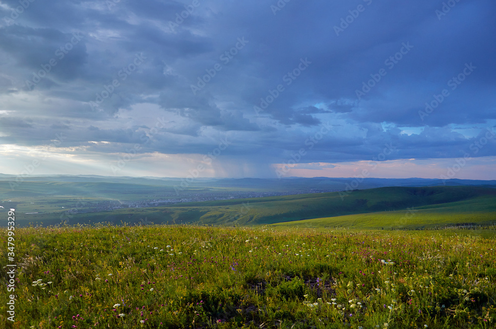 Steppes and distant green hills in the rain. Zabaykalsky Krai. Russia. Steppes and distant green hills in the rain. Zabaykalsky Krai. Russia.