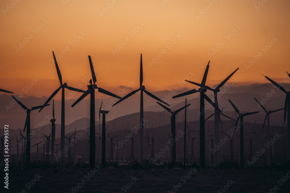 Wind Power Air Breeze Wind Generator turbines field in California at suset time. Green energy concept. Wind Power Air Breeze Wind Generator turbines field in California at suset time. Green energy concept.
