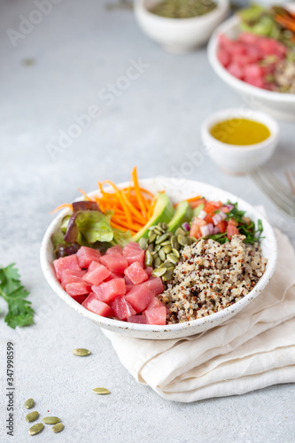 Healthy raw tuna bowl with quinoa and vegetales. Buddha bowl