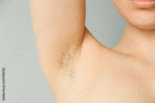 Woman's Underarm Hair Removal On Grey Background