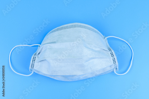 Protective face mask on a blue background. Healthcare and medicine concept