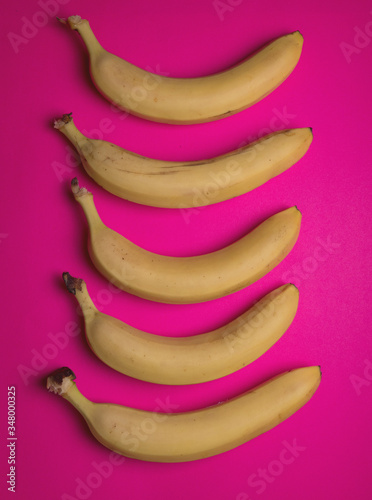 Many sweet ripe bananas on color background. Top view of fresh color bananas isolated on colorful background. Geometric colorful fruit pattern. Minimal flat lay style. bananas background.