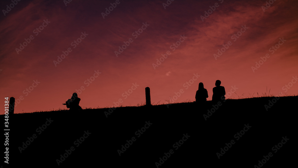 The shadow of the people sitting between them had pillars between them. The sky was magenta