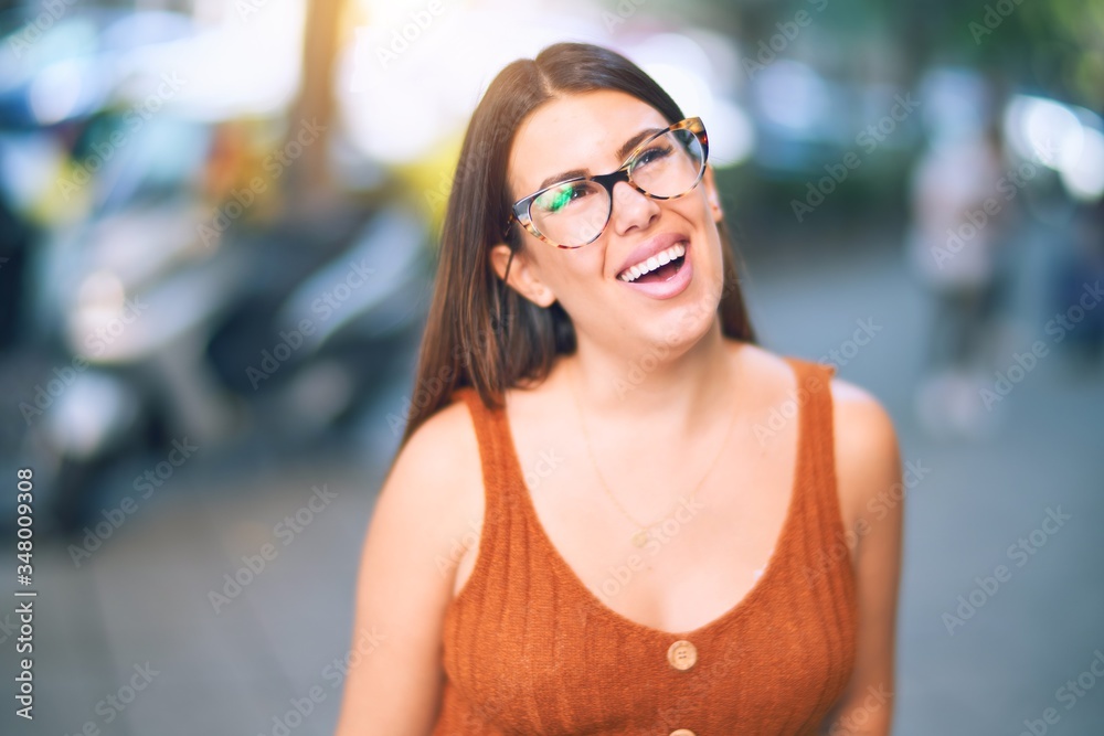 Young beautiful woman smiling happy and confident. Standing with smile on face at the town street Young beautiful woman smiling happy and confident. Standing with smile on face at the town street