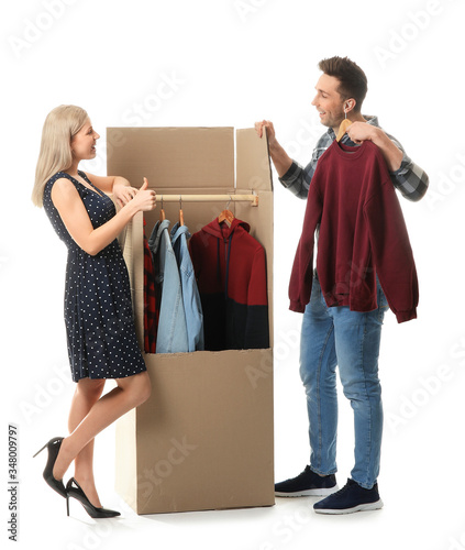 Young couple unpacking clot...