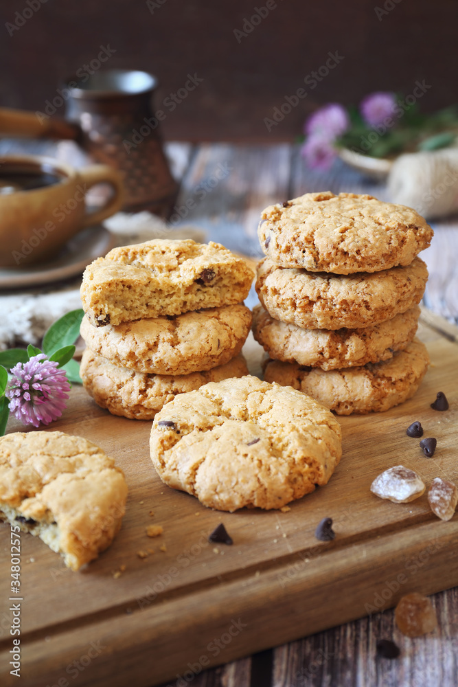 Oatmeal cookies with chocolate drops, cezve and cup of coffee