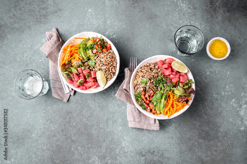Tuna poke bowl with quinoa and vegetales. budda bowl. Quinua tuna salad on gray background