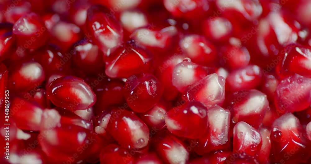 Grains of fresh pomegranate falling water drops. Grains of fresh pomegranate falling water drops.