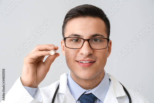 Male doctor with flashlight...