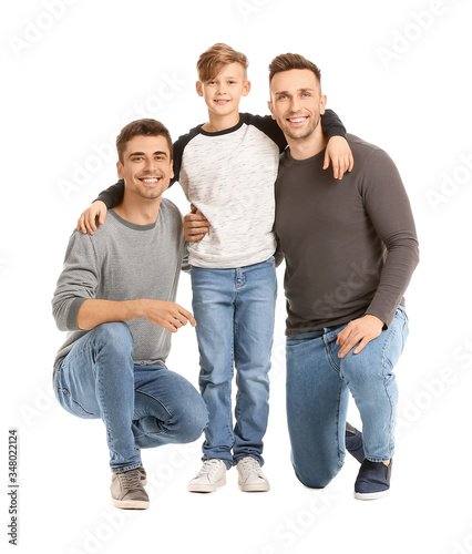 Happy gay couple with adopted child on white background