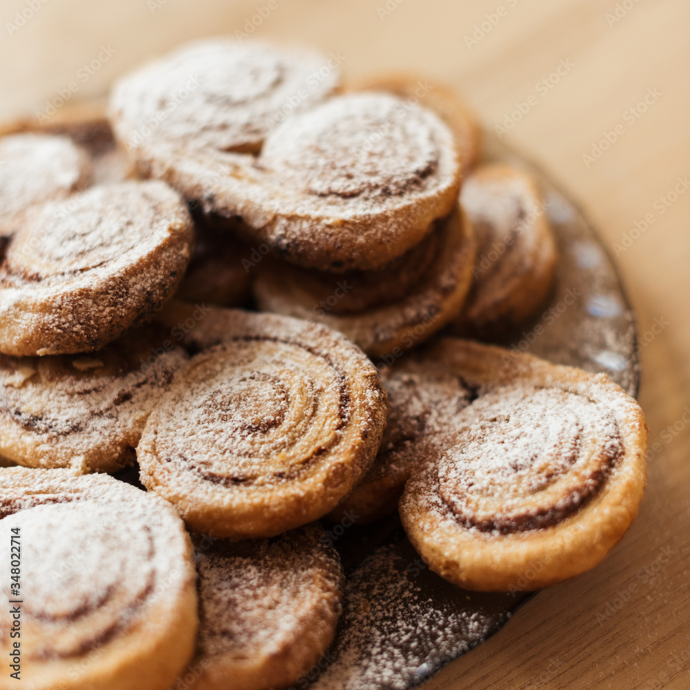cookies homemade cakes in powdered sugar on a dark plate cookies homemade cakes in powdered sugar on a dark plate