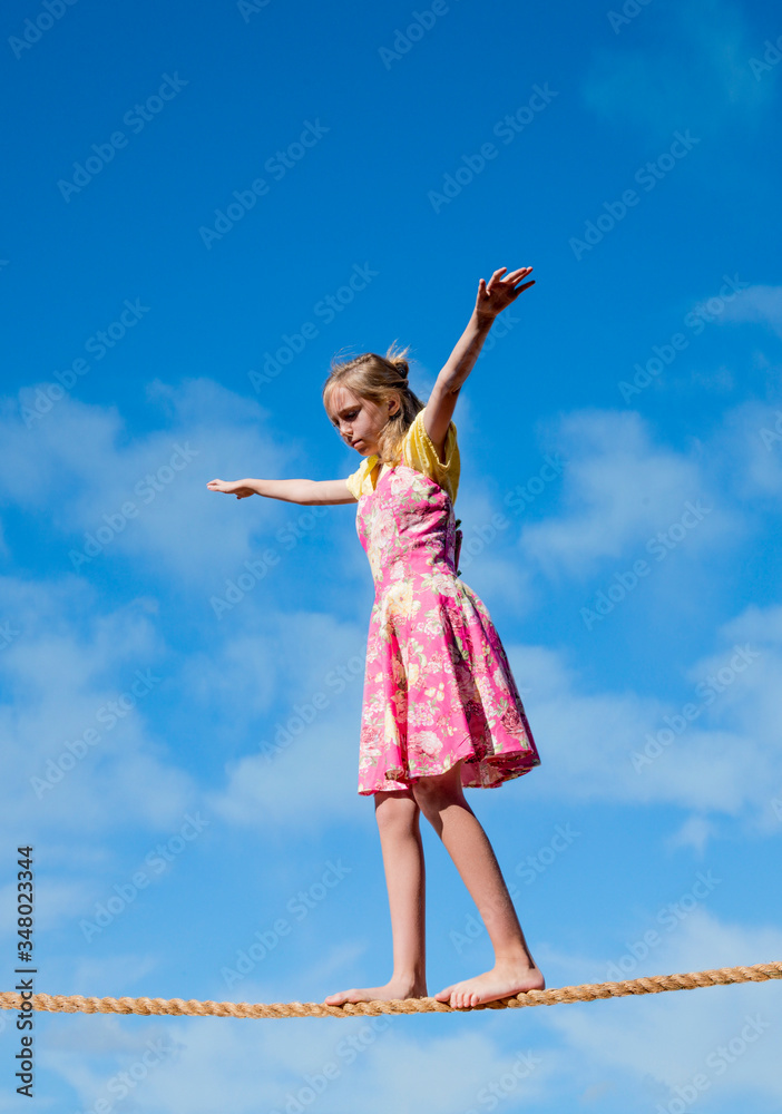 Photo concept art of young person on tightrope representing the process of growing up or making decisions. Photo concept art of young person on tightrope representing the process of growing up or making decisions.