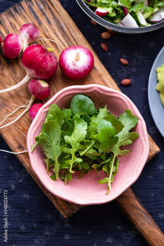 Fresh green rucola herb leaves sprouts and radish for salad