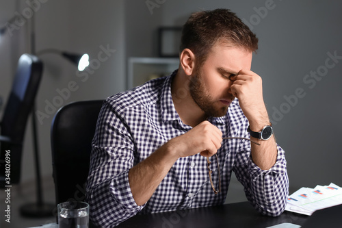 Tired businessman working i...