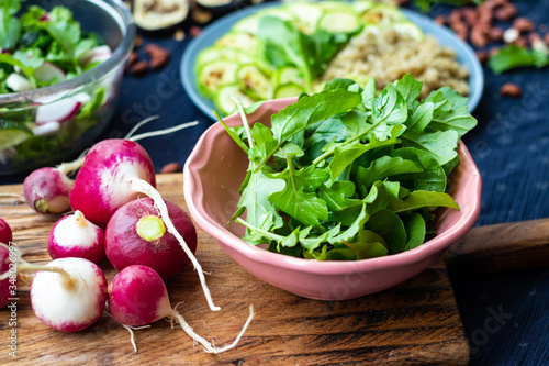 Fresh green rucola herb leaves sprouts and radish for salad