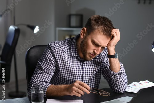 Tired businessman working i...
