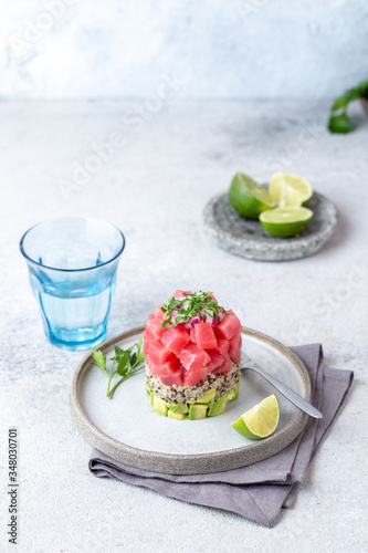 Tuna tartare tartar with avocado and quinoa. gourmet presentation with culinary ring on wite plate