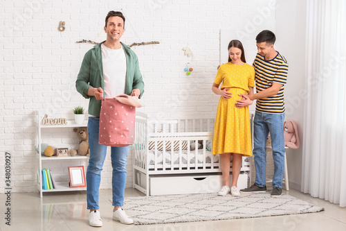 Gay couple with pregnant wo...