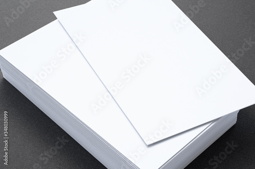 Close view of blank business cards on dark background. 3d illustration of vertical stack.