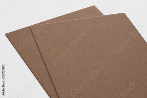 Close view of carton business cards isolated on grey. 3d illustration of vertical cards.
