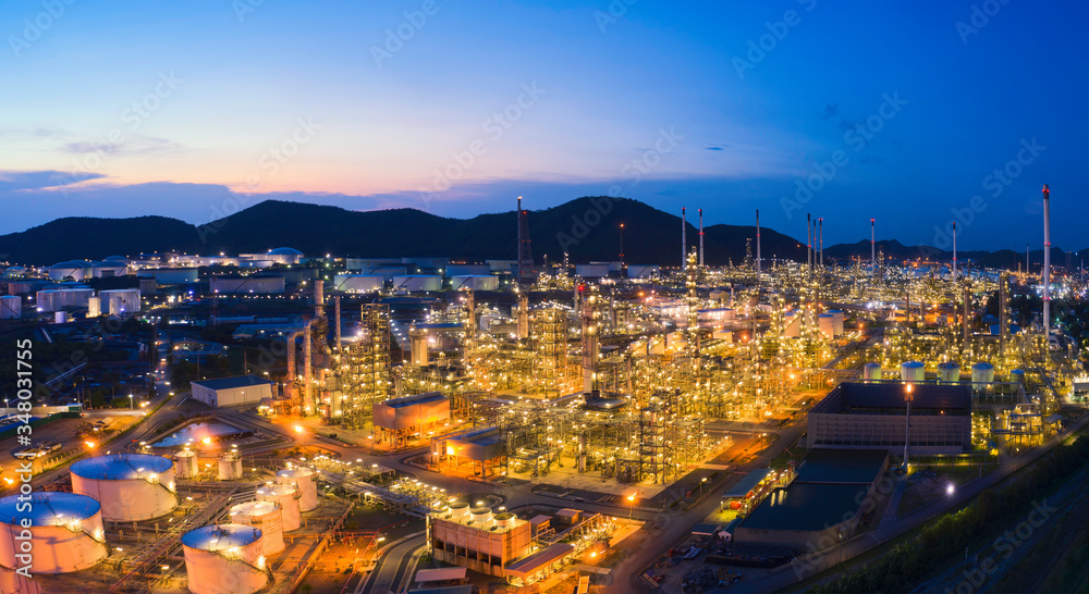 Aerial view drone of oil storage tank with oil refinery factory industrial. Oil refinery plant at beautiful sky sunset and twilight. industry factory concept and transportation. Panorama image.