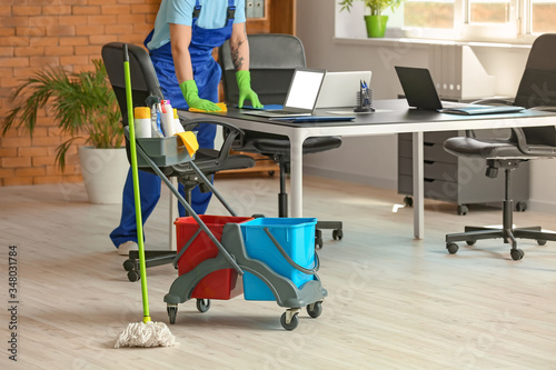 Male janitor cleaning in of...