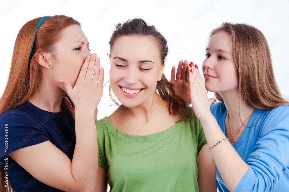 Gossips and Rumors Ideas. Three Young caucasian Girlfriends Sharing Their Secrets Whispering to Ears. Over White Background Gossips and Rumors Ideas. Three Young caucasian Girlfriends Sharing Their Secrets Whispering to Ears. Over White Background