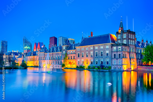 Picturesque Binnenhof Palace of Parliament inThe Hague in The Netherlands At Dusk. Against Modern Skyscrapers on Background