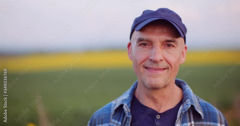 Positive Adult Farmer Smiling into Camera at Field - Agriculture. Positive Adult Farmer Smiling into Camera at Field - Agriculture.
