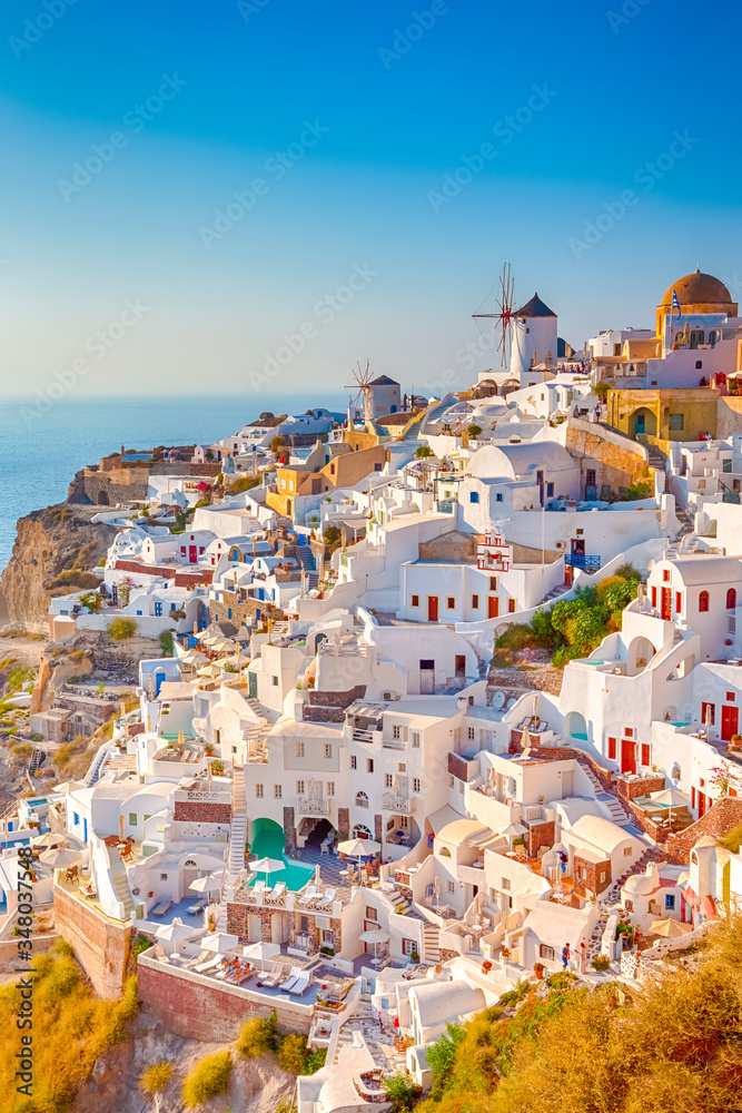 Φωτογραφία Traditional Colorful Houses and Windmills of Oia or Ia at Santorini Island at Noon