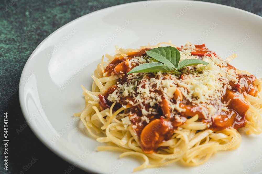 Cheesy and Meaty Linguine Spaghetti topped with Basil Leaves-Close up Side without Fork Cheesy and Meaty Linguine Spaghetti topped with Basil Leaves-Close up Side without Fork