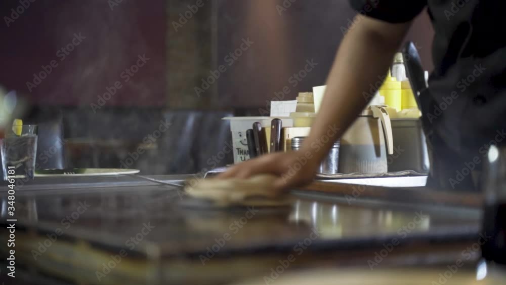 Japanese hot plate cleaned by chef with wet towel creating steam, slowmo HD Japanese hot plate cleaned by chef with wet towel creating steam, slowmo HD